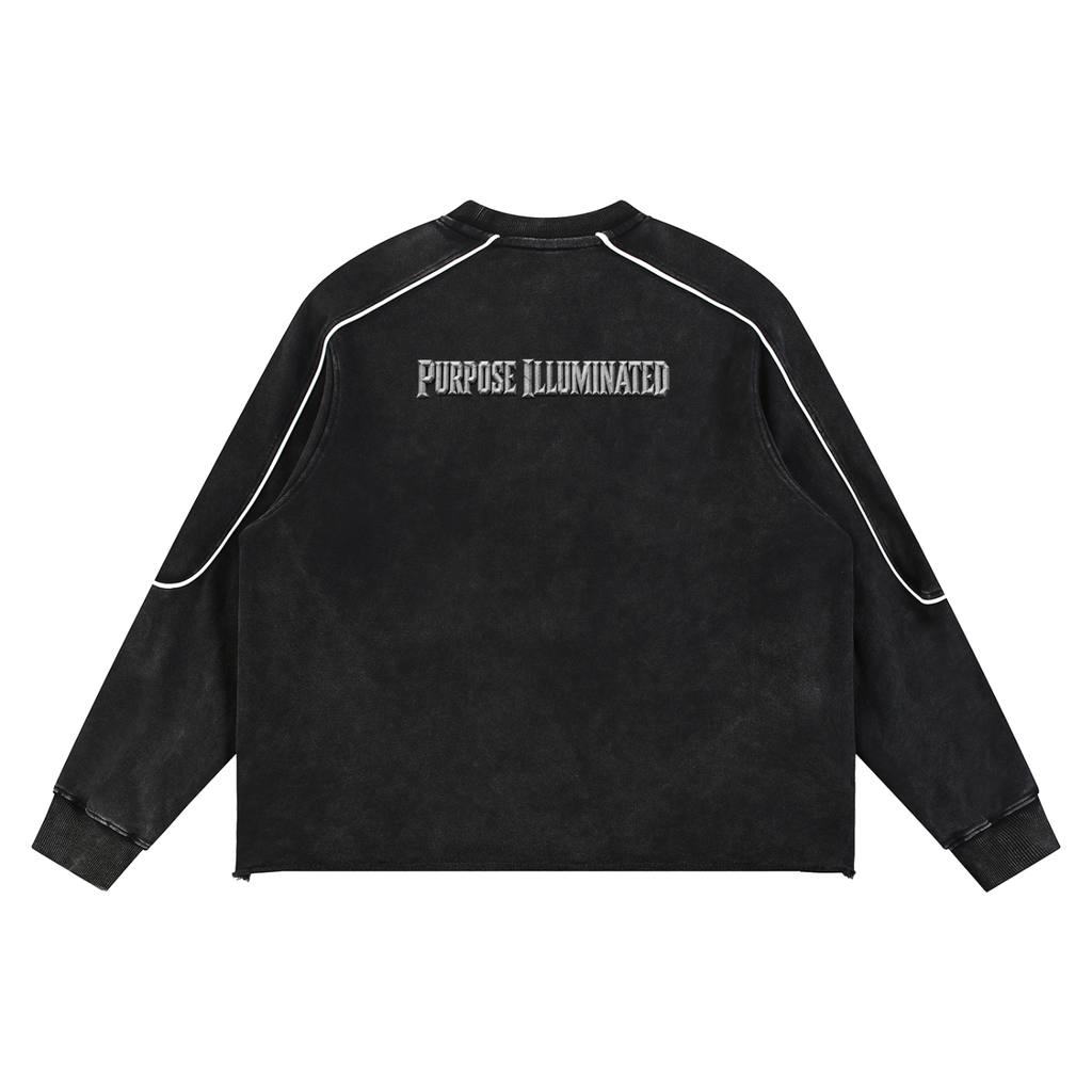 Back view of black mineral wash WHYELUME sweatshirt with pink Purpose Illuminated text and white piping