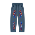 Front view of haze blue WHYELUME Purpose Illuminated heavyweight sweatpants with blue and orange flame graphics down both legs