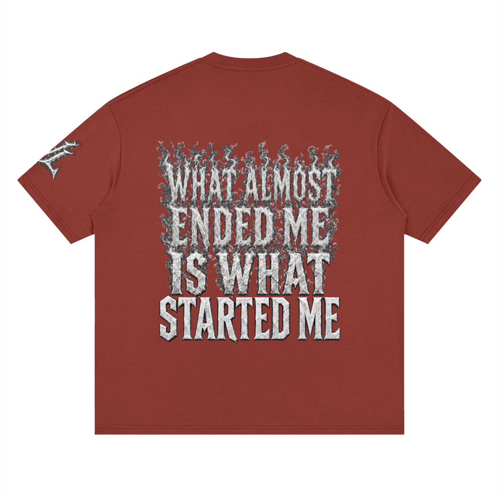 Back view of brick red WHYELUME What Started Me drop shoulder tee with white smoke What Almost Ended Me Is What Started Me graphic