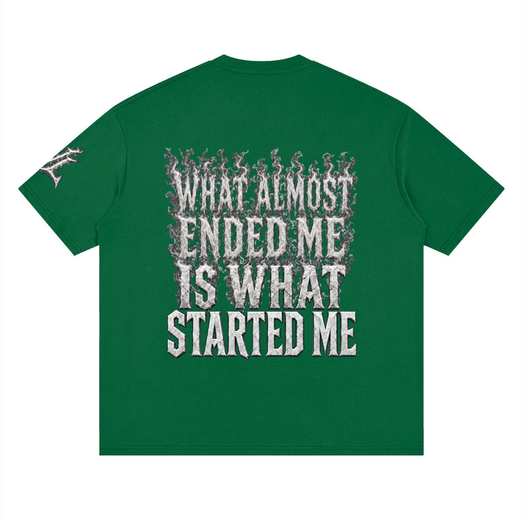 Back view of green WHYELUME What Started Me drop shoulder tee with white smoke What Almost Ended Me Is What Started Me graphic